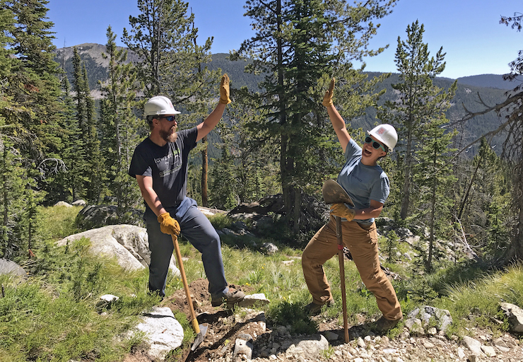 Two volunteers giving a long-distance high five