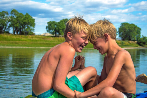 Two little boys laugh together on Missouri River