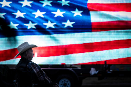 cowboy in front of flag screen